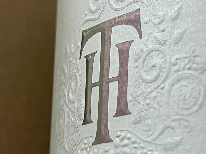 Embossed wine label detail on textured paper