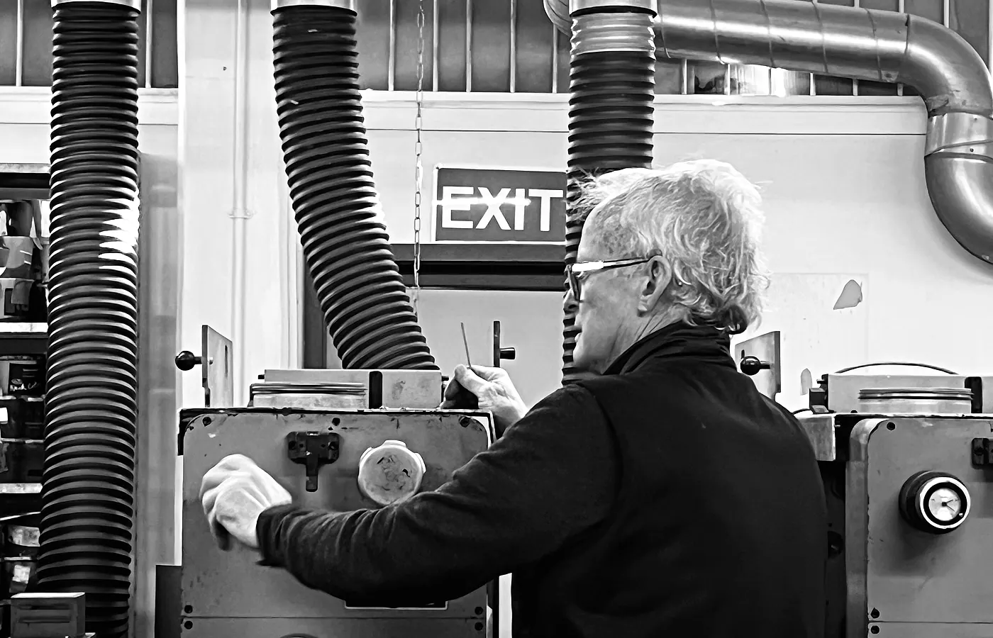 Press operator checking label production during a run